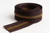very dark purplish brown zipper tape role with corn bronze teeth